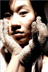 Yi hands covered with lace gloves with her face between them