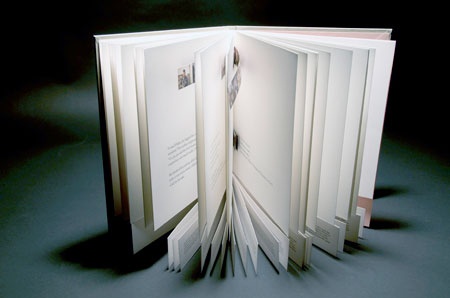 A book stand open towards viewer, showing 

bottom pages of 

text separated from top.